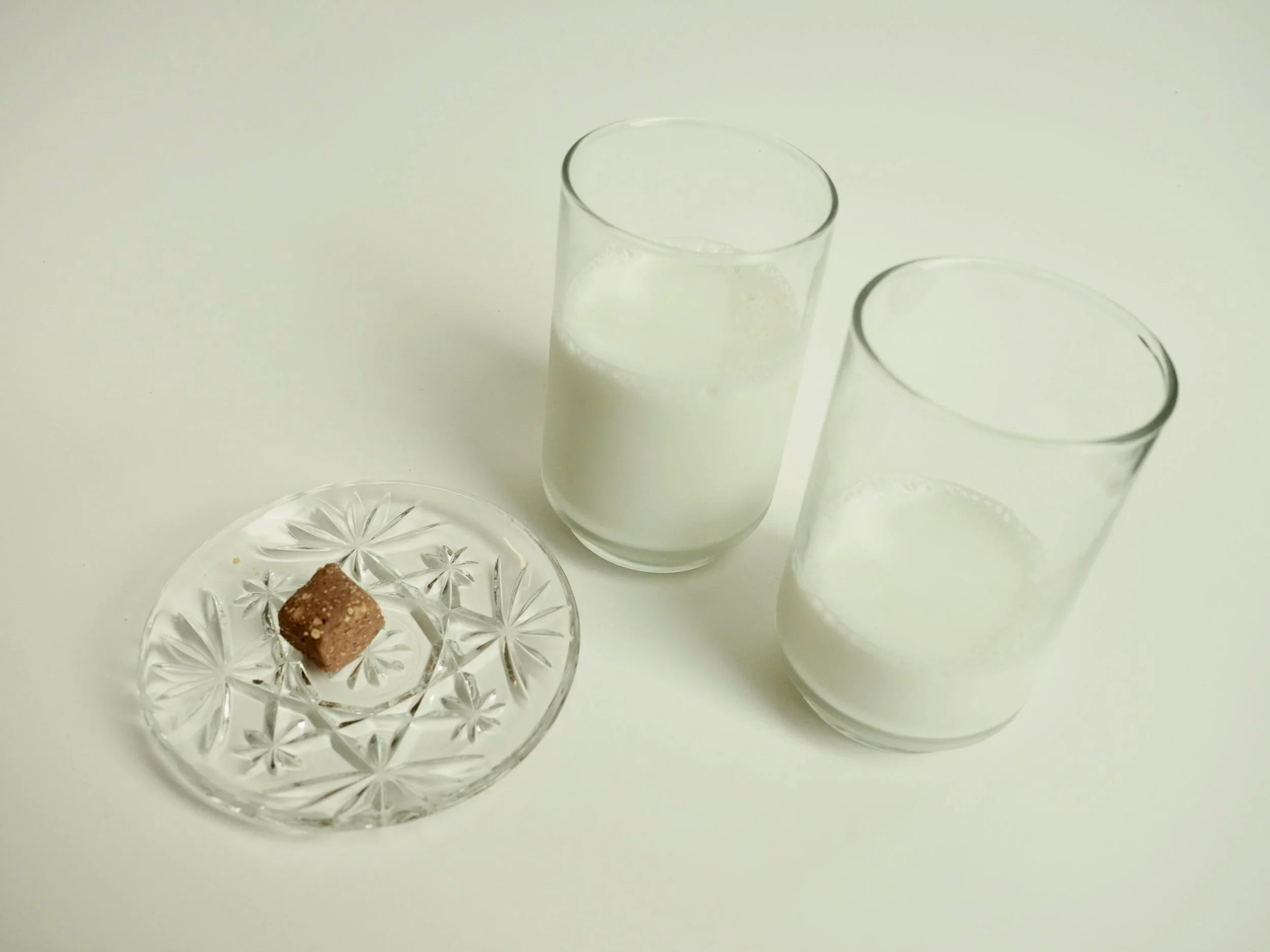 Two glasses of milk and a calcium chew