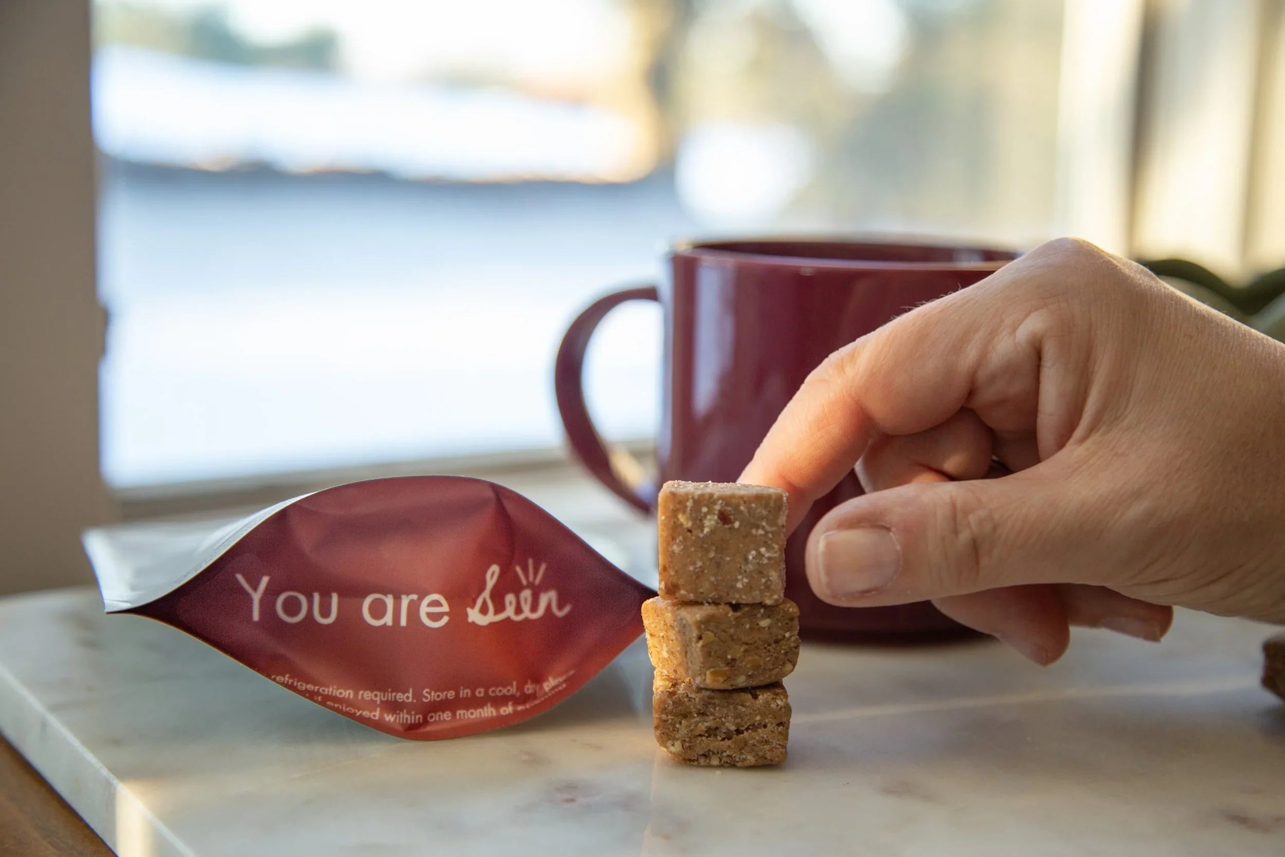 Calcium chew with hand about to pick up one calcium chew