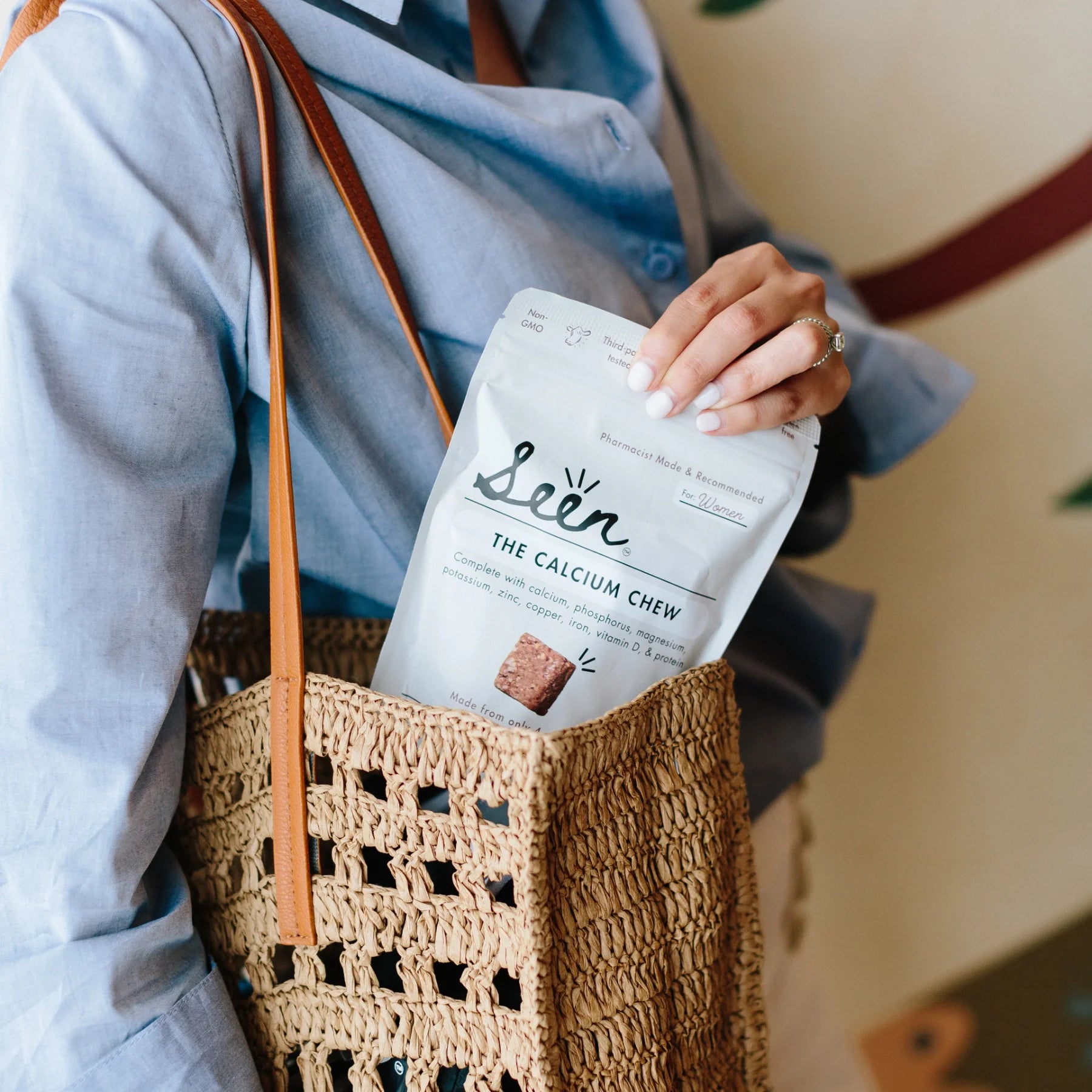 Woman with purse putting Seen Calcium Chews inside