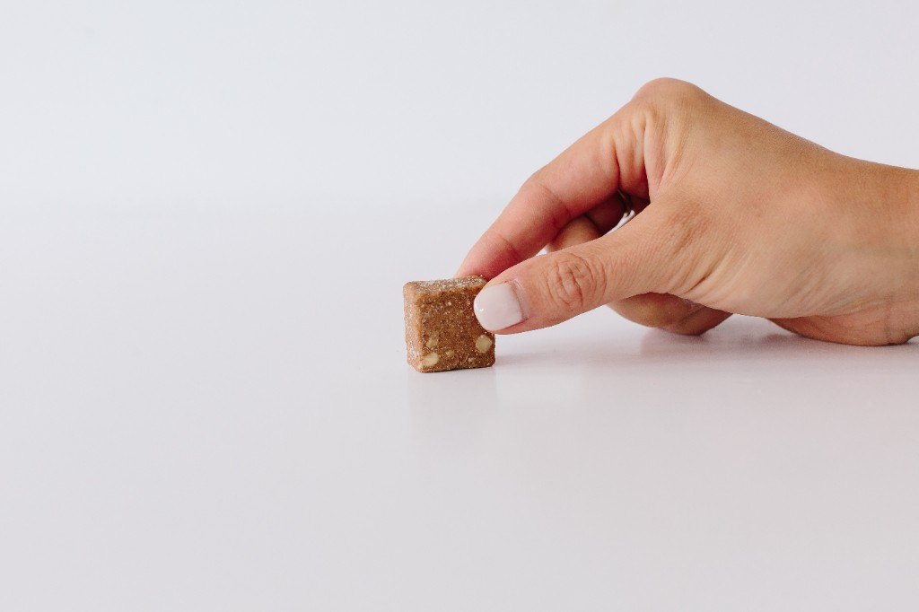 A Seen calcium chew held between two fingers
