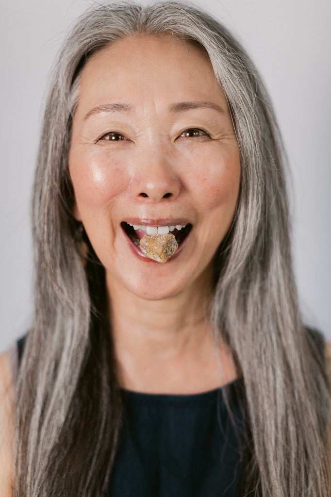 A customer holding a Seen calcium chew between her teeth